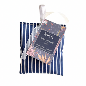 Scented drawer sachet in blue on a white background with Milk branding 