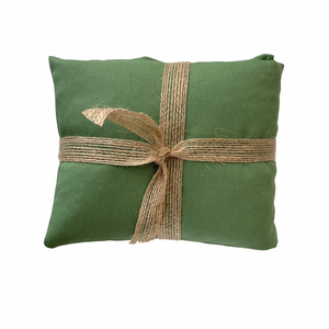 Pistachio coloured wheat bag with a burlap ribbon on a white background