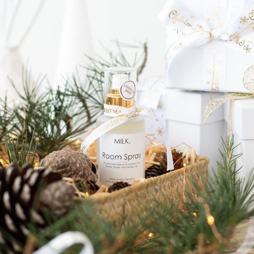 christmas room spray on table with pine cones gift box ribbon
